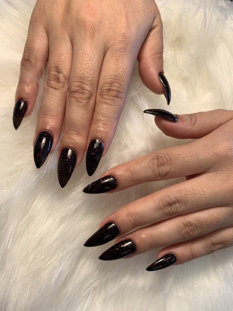 Glossy black stiletto nails