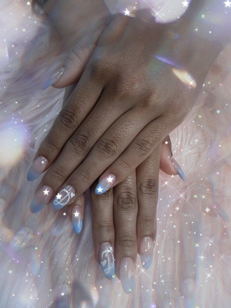 Blue and white ombré gel nails with star accents